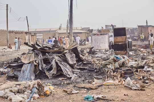 Kano, Nigeria - 27 January 2024: View of debris and charred remains scattered across the ground near Dakata fire service, Fatima market, under a hazy sky.
