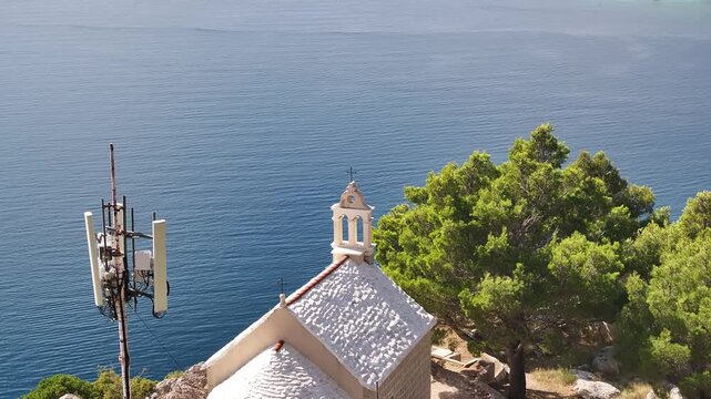 Drone aerial of St Stephen church in Borak with panoramic view of Omis and coastline.