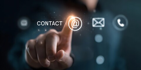 Obraz premium A human finger is precisely touching a bright glowing email icon symbol on an advanced virtual screen indicating digital communication and interactive connectivity in a modern dark setting