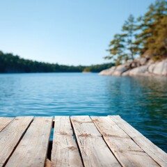 Fototapeta premium Sunlit wooden pier foreground with clear blue lake and blurred forested islands creating tranquil summer vista