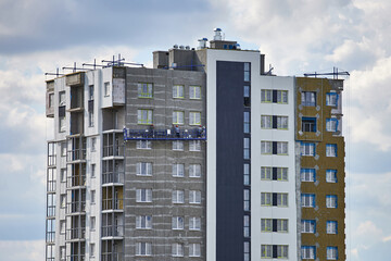 Fototapeta premium The process of insulating a modern multi-story building.