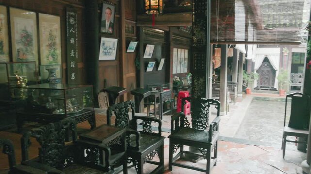 Hoi An, VIETNAM : Interior of a traditional historical Vietnamese home in Hoi An, Vietnam. The space features ornate wooden furniture, artwork, and decorative objects, showcasing Vietnamese culture