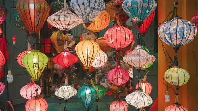 A vibrant display of colorful silk lanterns illuminates the streets of Hoi An, Vietnam. These traditional Vietnamese lanterns are popular souvenirs for tourists.
