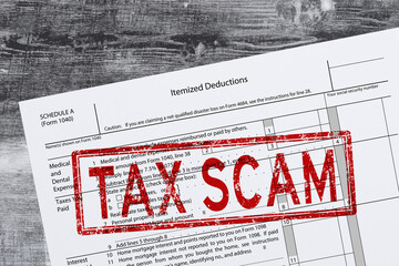 Tax scam stamp on tax form fraud concept