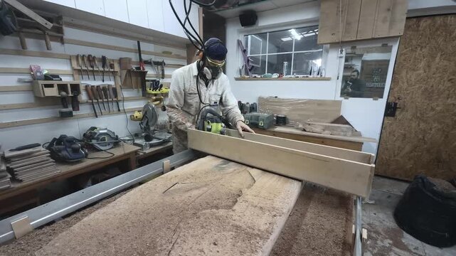 Focused Carpenter Leveling Live Edge Slab for Epoxy River Table with Power Router in Home Workshop Wide Angle Orbit Shot Real Time Millwork