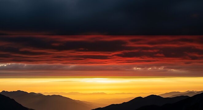 Vibrant sunset over mountain range with orange and red clouds