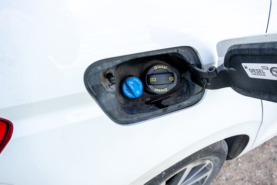 Car compartment with holes for refueling diesel fuel and adblue