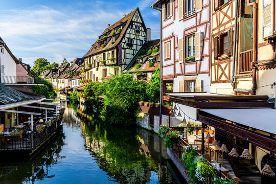Patios, restaurants and half-timbered houses line the canals in La Petite Venice in Colmar, France.