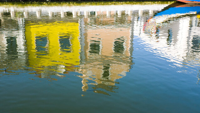 Europe, Portugal, Aveiro. Reflections of the colorful houses along the Sao Roque Canal in Aveiro.