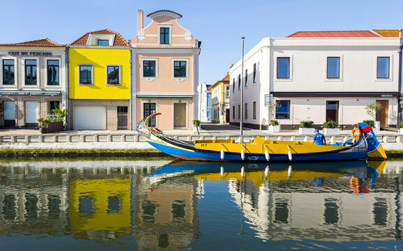 Europe, Portugal, Aveiro. Traditional Moliceiro boats along the Sao Roque Canal with reflections of the colorful houses.