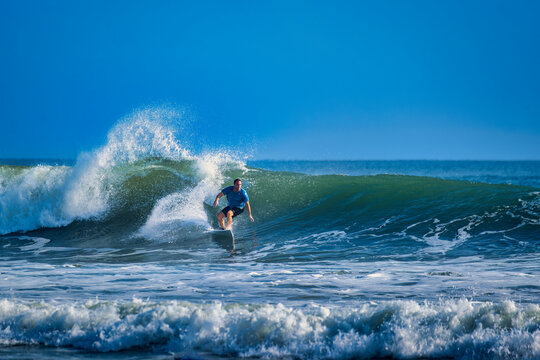 Surfer off the beach in New Smyrna Beach Florida, USA
