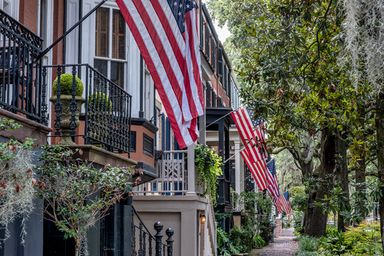 Charming American flags adorn historic row houses in Savannah, Georgia,USA