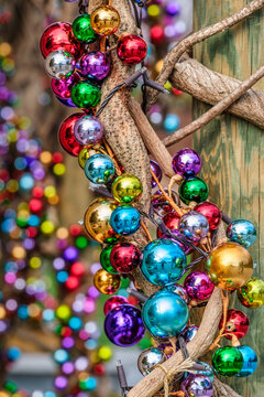 Vibrant Holiday Spirit: Colorful Christmas Ornaments Adorning Rustic Wooden Branches
