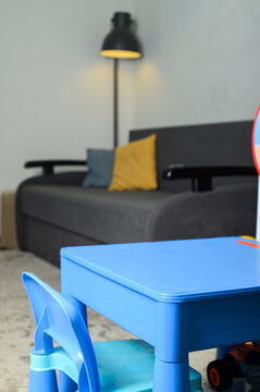 Small blue children&rsquo;s table and chair in modern living room interior