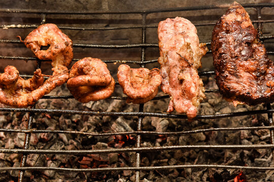Cow bowels presented on a wooden board with ingredients, ready to grill