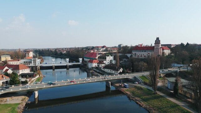 Aerial drone rising shot of road bridge over Elbe river with historic castle and town, Brand&yacute;s nad Labem, Czech Republic