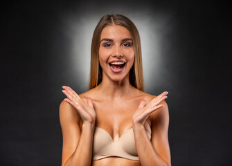 Fototapeta premium Excited Young Woman Expressing Surprise With Open Hands Gesture.