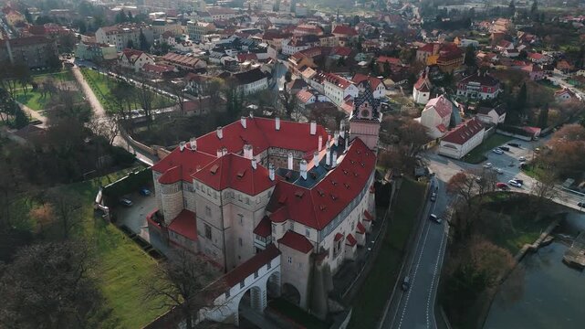 Aerial drone orbit around Brand&yacute;s nad Labem castle showing entrance bridge and moat, Czech Republic