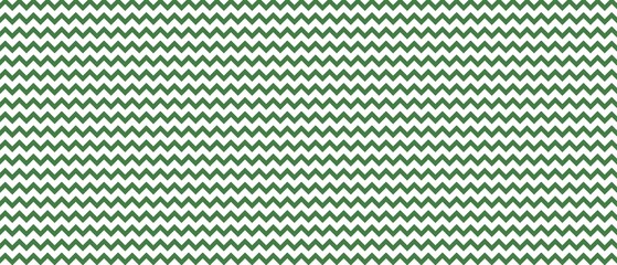 Obraz premium ​Seamless green and white zigzag chevron pattern background. Classic geometric wavy lines texture for wallpaper, textile, wrapping paper, and digital graphic design.
