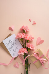 Happy Mother's Day vertical greeting card with pink carnation bouquet, kraft wrapped gift tied with...