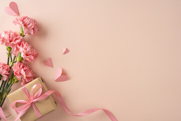 Happy Mother's Day arrangement featuring pink carnations and a kraft-wrapped gift tied with pink...