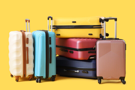Many suitcases on yellow background