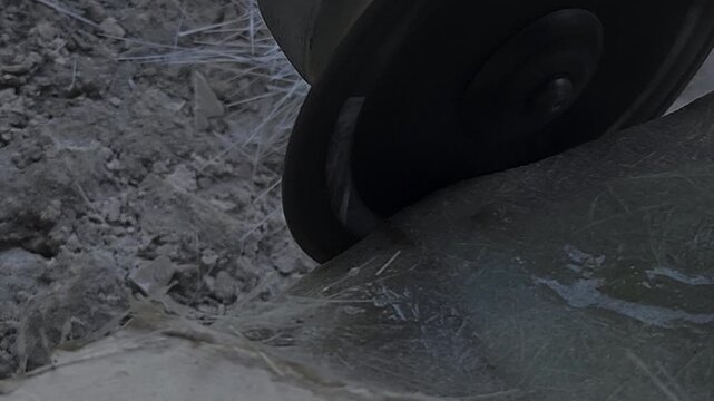Close-up of a skilled artist using an angle grinder to cut and shape a fibre sculpture, captured in slow motion. The scene highlights precision craftsmanship, manual work, and industrial tools, India