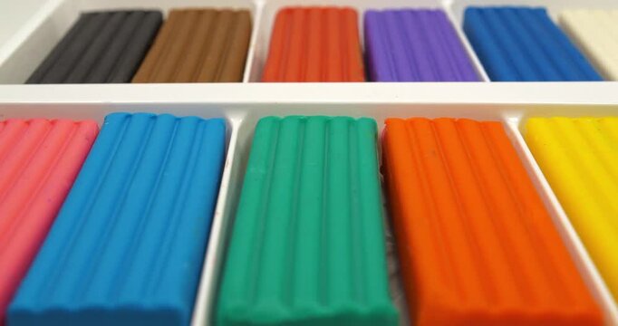 Colorful blocks of modeling clay for art projects. Colorful pieces of plasticine in a box. Soft modeling clay blocks for creative fun. Fun clay blocks for skillful modeling