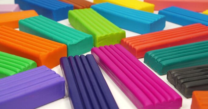 Bright plasticine ready for shaping and modeling fun. Soft clay blocks for fun and skillful modeling. Colorful plasticine pieces ready for creative play