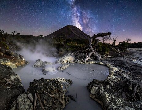 Nightscape of boiling mud pots at Las Pailas, Rincon de la Vieja. Geothermal steam, vertical Milky Way, and volcanic rocks with sharp detail. Costa Rica nature and astronomy concept.