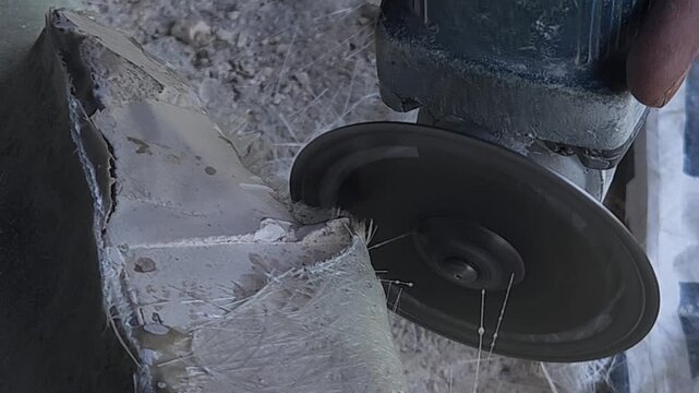 Close-up of a skilled artist using an angle grinder to cut and shape a fibre sculpture, captured in slow motion. The scene highlights precision craftsmanship, manual work, and industrial tools, India