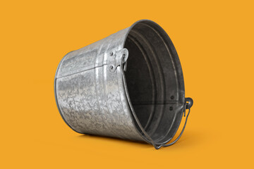 Galvanized metal bucket lying on side isolated on orange background, empty rustic pail container with handle, industrial household object, cleaning and gardening supply © Pixel-Shot