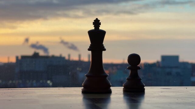 A conceptual minimalist photo focusing on a single wooden chess queen piece on a board. The shallow depth of field isolates the subject against a bright, blurred background, representing strategy, lea