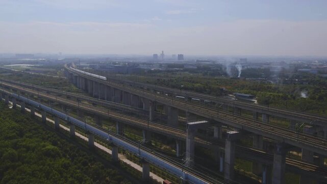 High-speed railway train traveling on the Beijing&ndash;Shanghai High-Speed Railway (Jinghu HSR) in China. Modern bullet train running on elevated tracks through the countryside, showcasing advanced transpo