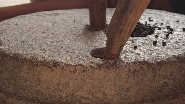 Traditional Stone Grinder in Motion, Manual Grain Grinding Process and Rural Food Preparation Close Up