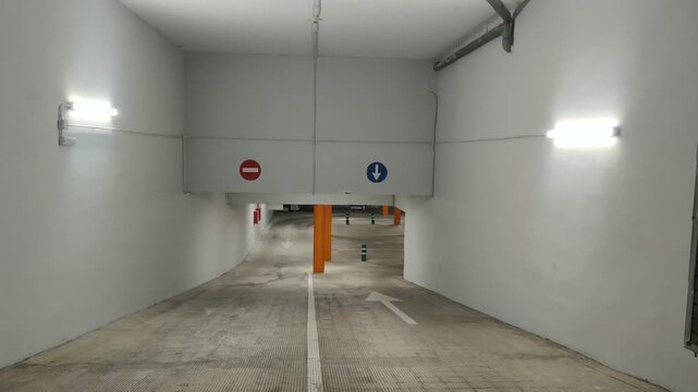 Driving down ramp into an empty underground parking garage