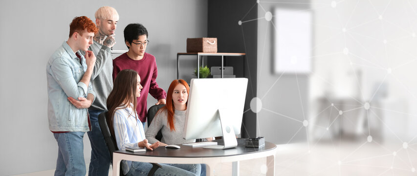 Team of young programmers working with computer in office