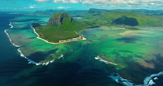 Aerial view of Le Morne Peninsula, Le Morne Brabant Mountain. Sea lagoon formed by coral reefs, Mauritius Island, Africa, Indian Ocean. Underwater waterfall in Le Morne