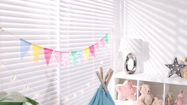 Child's room decorated with colorful flags and decorative lights. Camera moving forward