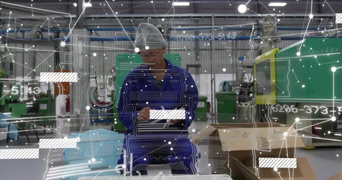 Male factory worker reaching into tray inspecting assembling parts for packing overlays appearing