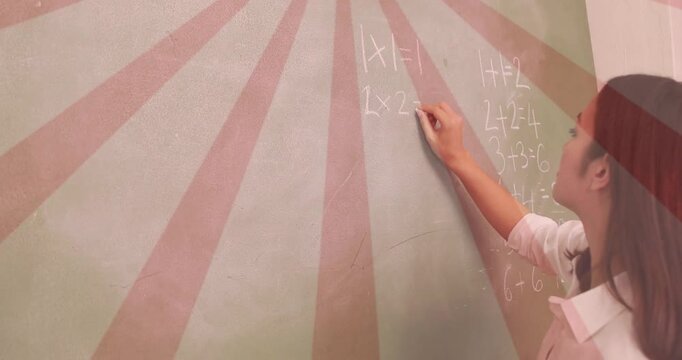Woman placing chalk and writing equations on board for education, sunburst backing addition column