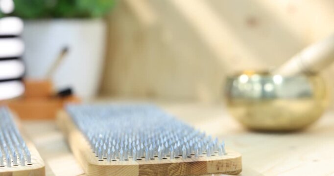 Standing on nails. Two Sadhu boards on wooden table, closeup