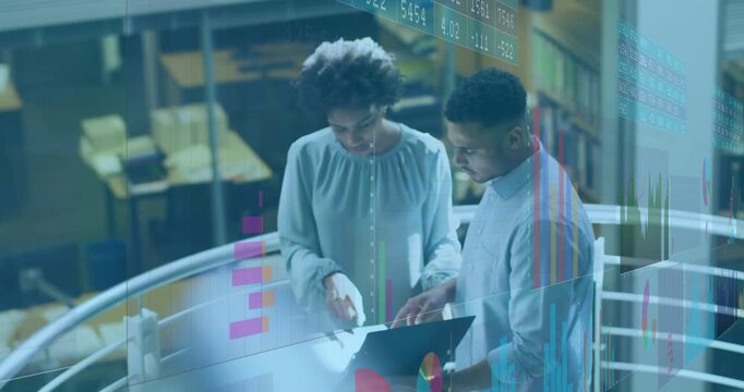 Vertical video: Man holding laptop overlaying finance charts woman pointing man scrolling reviewing