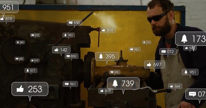 Vertical video: Worker watching lathe as alerts growing over lathe, tracking interest in metal shop