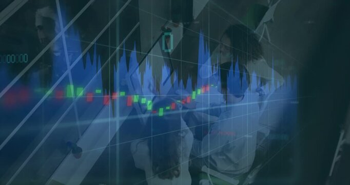 Vertical video: Waveform and candles shifting, analysts leaning, typing, analyzing monitor finance