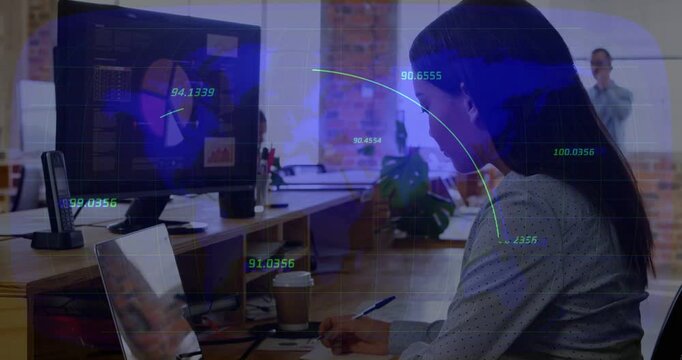 Vertical video: Woman reaching pen, writing notes while data arcs link monitor and laptop, business