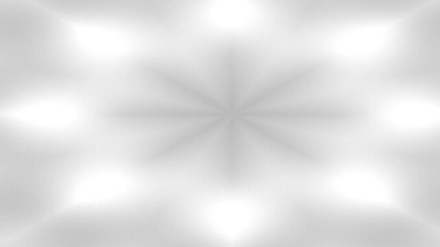 A soft, blurred, symmetrical grayscale abstract pattern with eight radiating points.