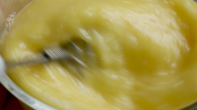 4K Slow Motion of Finishing Whisking Eggs in Glass Bowl