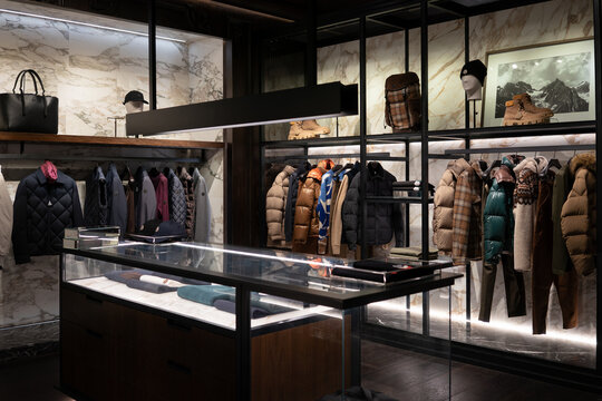 Apparel displayed on hangers inside Moncler store