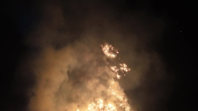 smoke and flames from brush fire at night near boone nc, north carolina